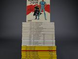 many books stacked on top of each other on a table