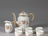 five cups and a teapot on the table