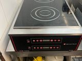 a black stove top in the corner of a kitchen