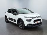 the white citrole is parked in a large room