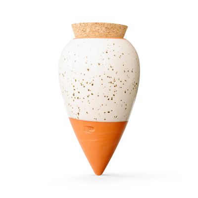 a white and orange vase with a cork top on a white background
