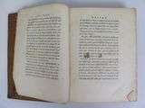 a book open on a white table with writing on it