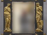an image of a gold and black picture frame on a wooden stand