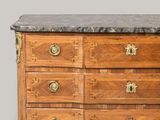 a wooden chest of drawers with a marble top