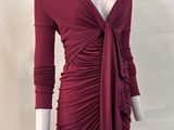 a mannequin wearing a red dress with long sleeves