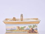 a bathtub with a painting on the side of it