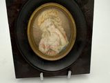 a picture of a woman in a hat on a plaque