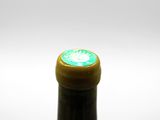 a bottle of wine that has a green label on it