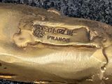 a close up of a gold baseball glove on a black surface