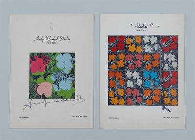 two prints of flowers are on display on a wall