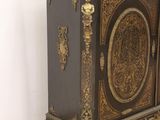 a black and gold cabinet sitting on the floor