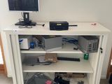 a white cabinet with a computer on top of it