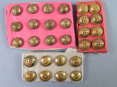 two boxes of gold coins sitting next to each other on top of a table