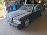a car that is parked in a garage with the hood up