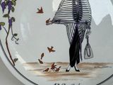 a plate with a picture of a woman holding a purse