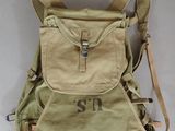 beige canvas backpack with initials on the front and shoulder straps