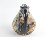 a black and white vase with a painting on it