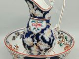 an image of a blue and white porcelain pitcher and saucer on a saucer