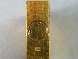 an image of a gold bar with a ring on it