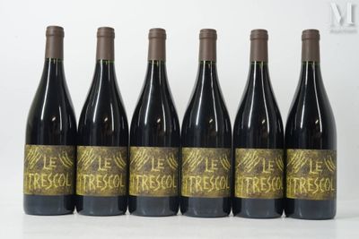 six bottles of red wine are lined up on a table