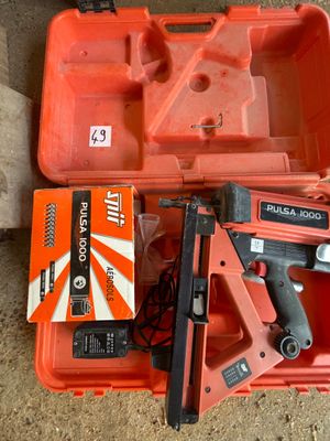 une boîte à outils orange contenant une agrafeuse et une agrafeuse