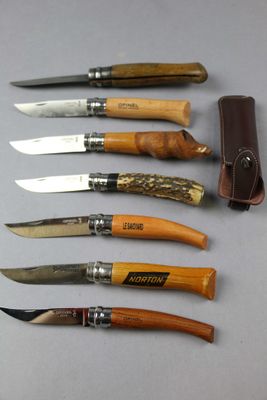 six different types of knives are lined up on a table