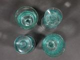 four glasses that are sitting on a table