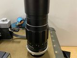 a camera lens sitting on top of a piece of luggage