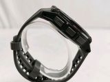 a close up of a watch on a clear stand