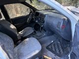 an image of a dirty car with the front seats down