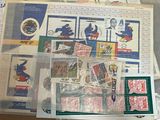 a lot of stamps and stamps in a bag on a table