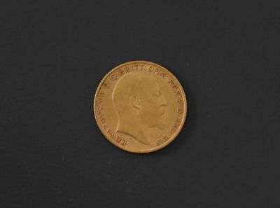 a close up of a gold coin on a black surface