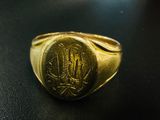 an image of a gold signet ring with a monogram on it