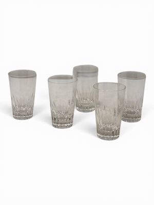 six glasses are lined up in a row on a white surface