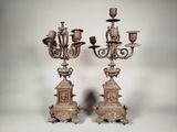 pair of antique bronze candelabs with candles on stands