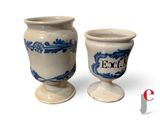 two blue and white vases sitting next to each other