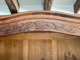 a close up of a bed with a wooden headboard