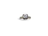 a close up of a diamond ring on a white background