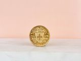 a gold coin sitting on top of a marble counter top