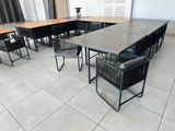 a table and chairs in a room with white tile flooring