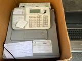 a box with a calculator and a laptop in it