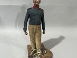 a figurine of a man standing on a rope