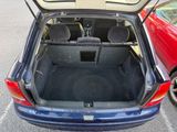 the back of a car with its trunk open in a parking lot