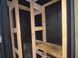 a picture of a bathroom with a wooden bench in the corner