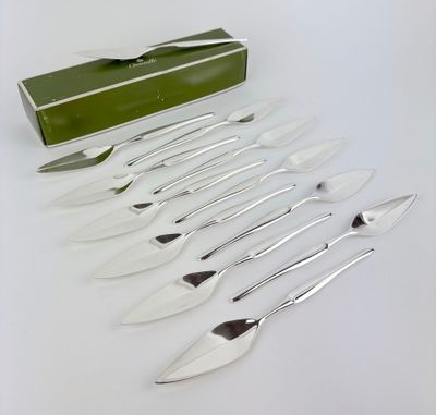 six forks and a knife in a box on a table