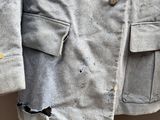 an image of a gray jacket with holes on it