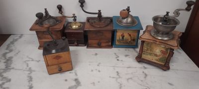 four different types of coffee grinders on a table
