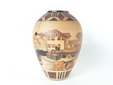 a vase with a painting on it on a white surface
