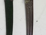 three different types of knives on a white surface