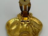 a gold colored object on a white surface